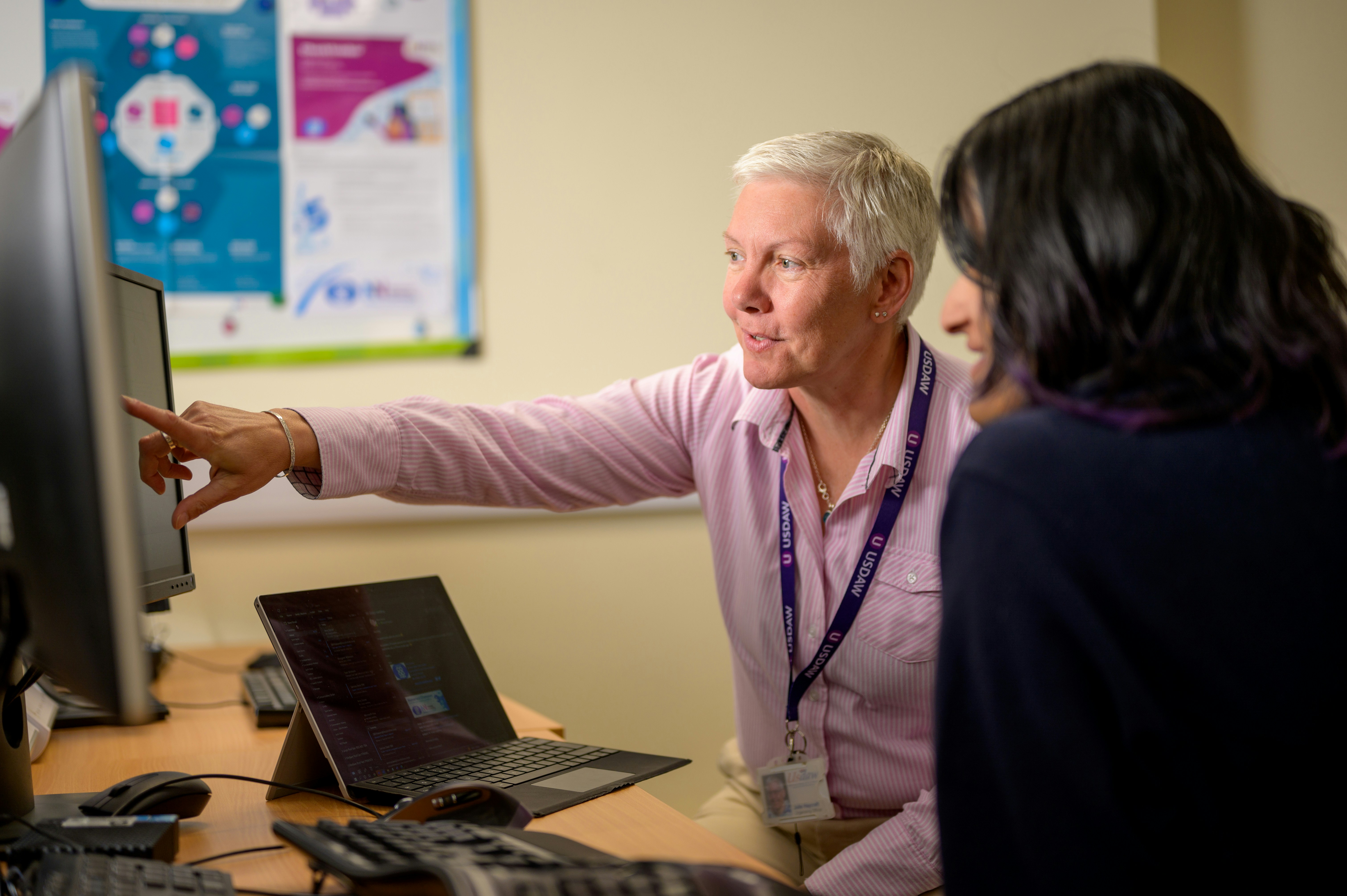 Senior using computer with assistance - compassionate technology support